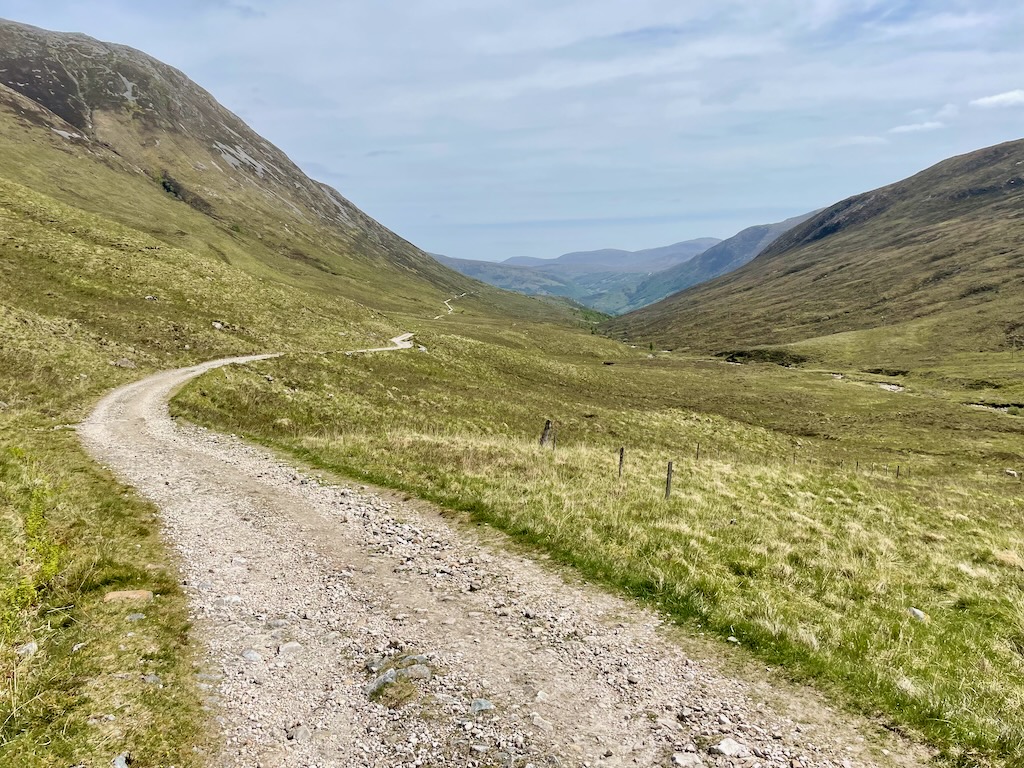 gravel track weaving down a glen